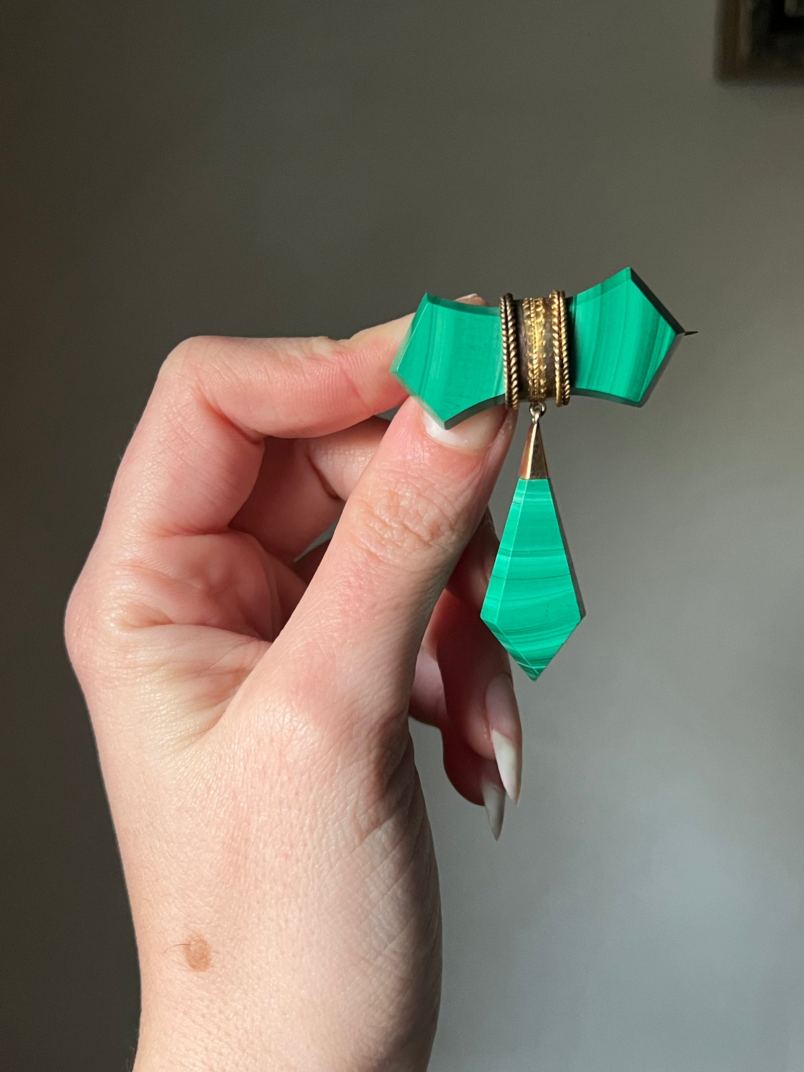 Antique malachite tie brooch with rich green stone and intricate gold-tone setting
