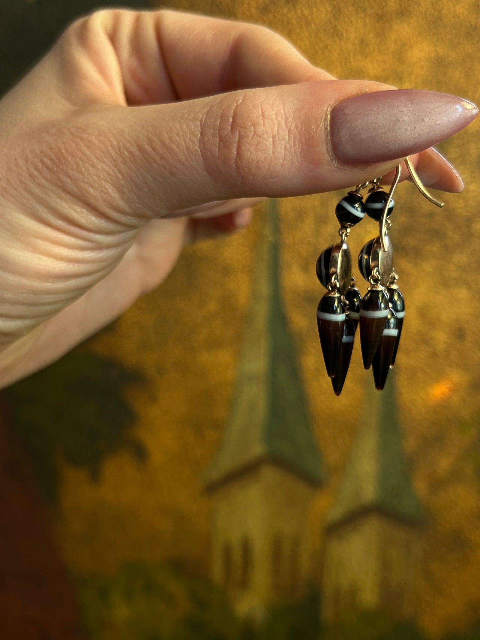 Archaeological Revival agate earrings with carved stones and ornate gold-style settings