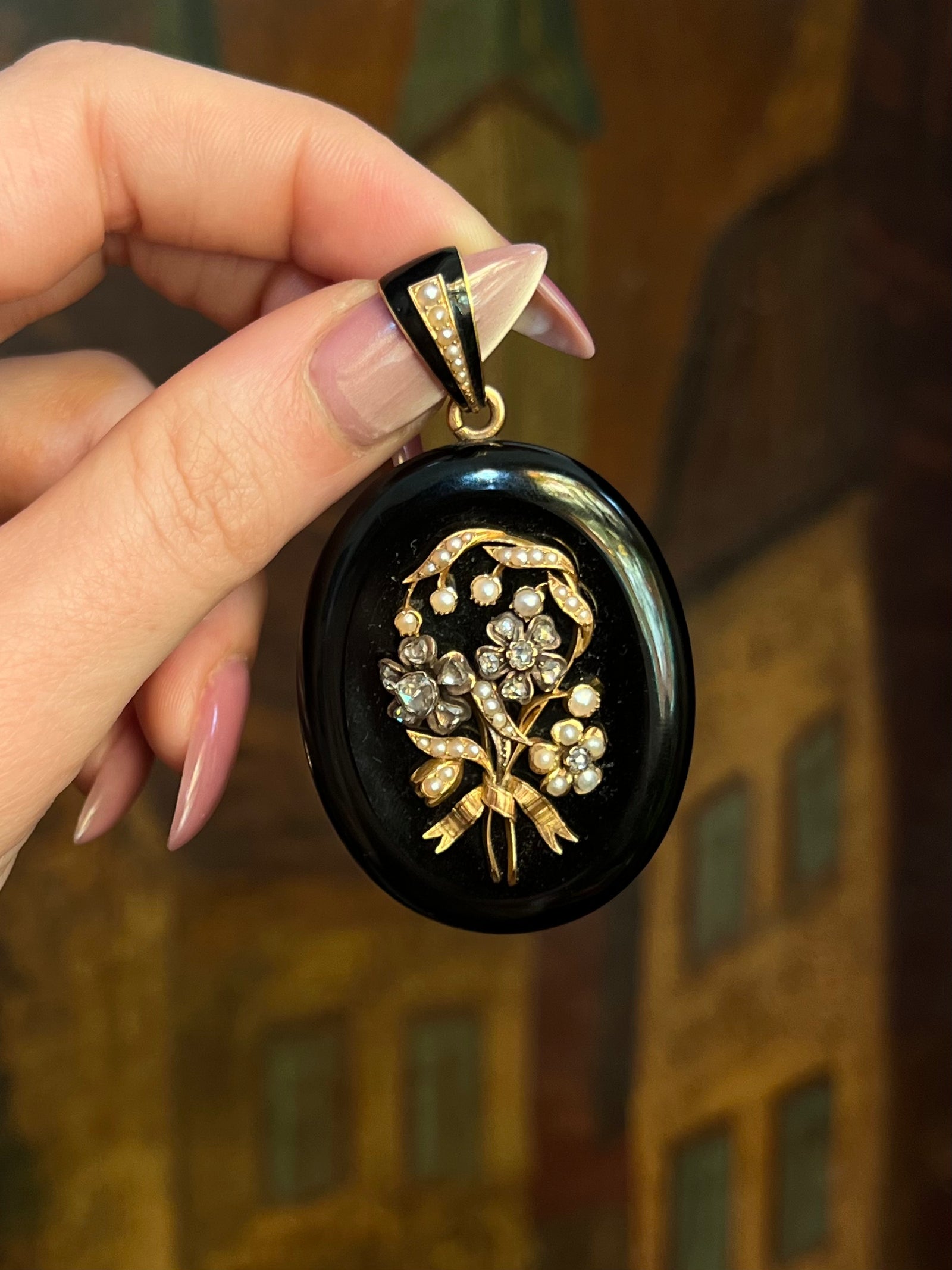 French onyx sentimental locket with diamond and pearl accents in an elegant antique setting