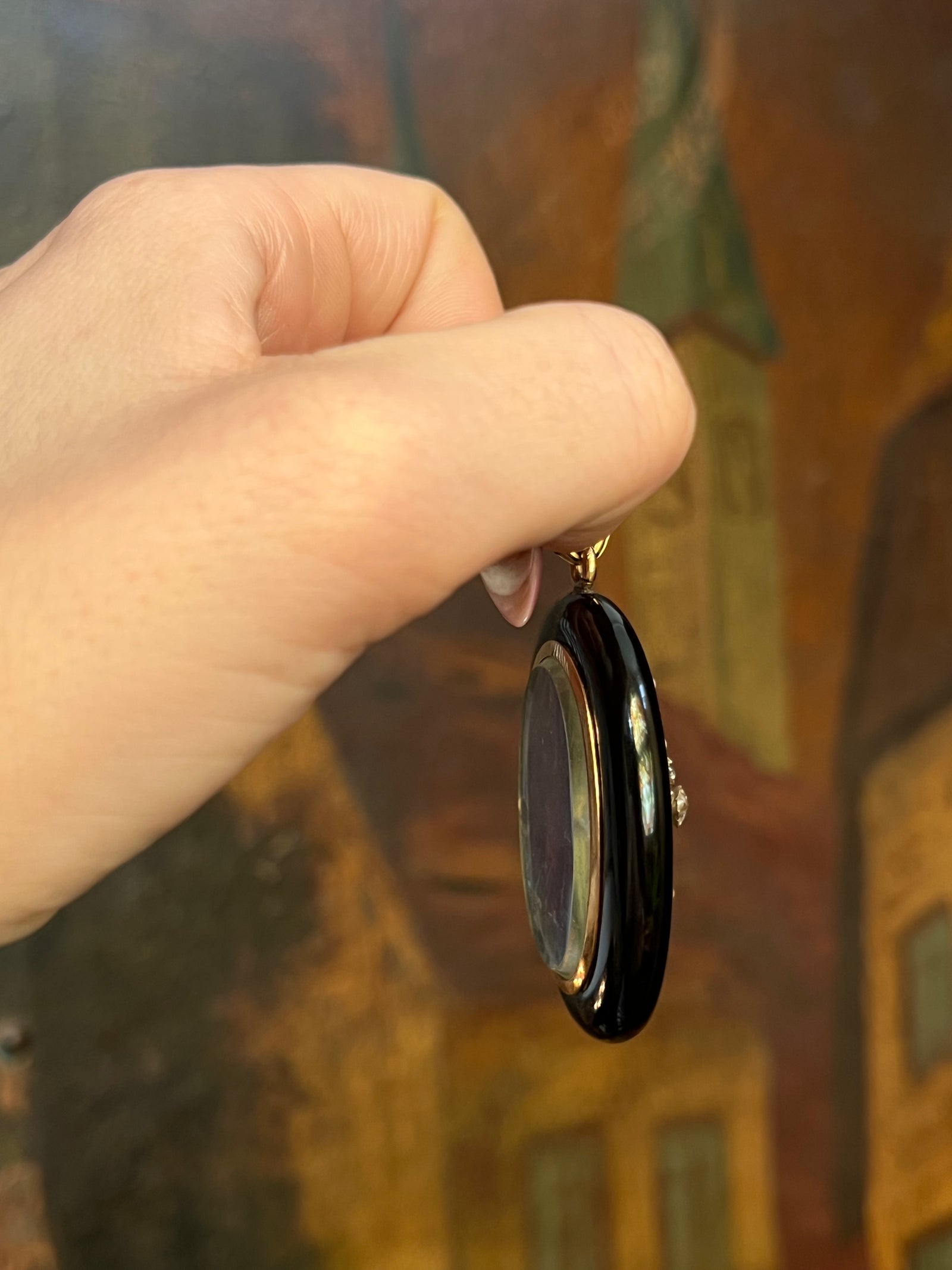 French onyx sentimental locket with diamond and pearl accents in an elegant antique setting