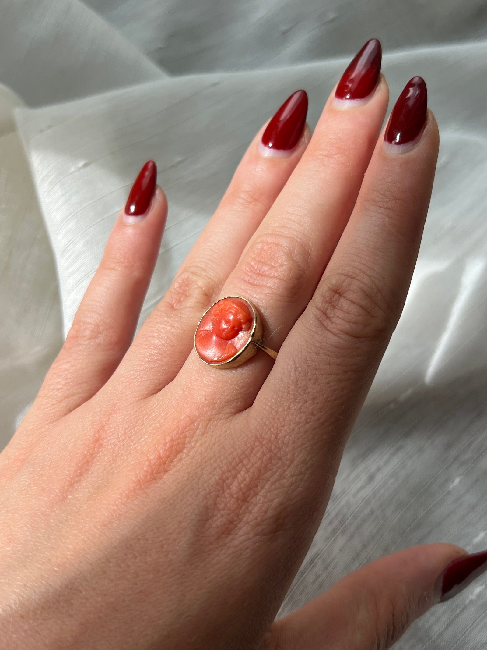 Regency-era coral cameo ring with intricately carved profile in antique gold setting