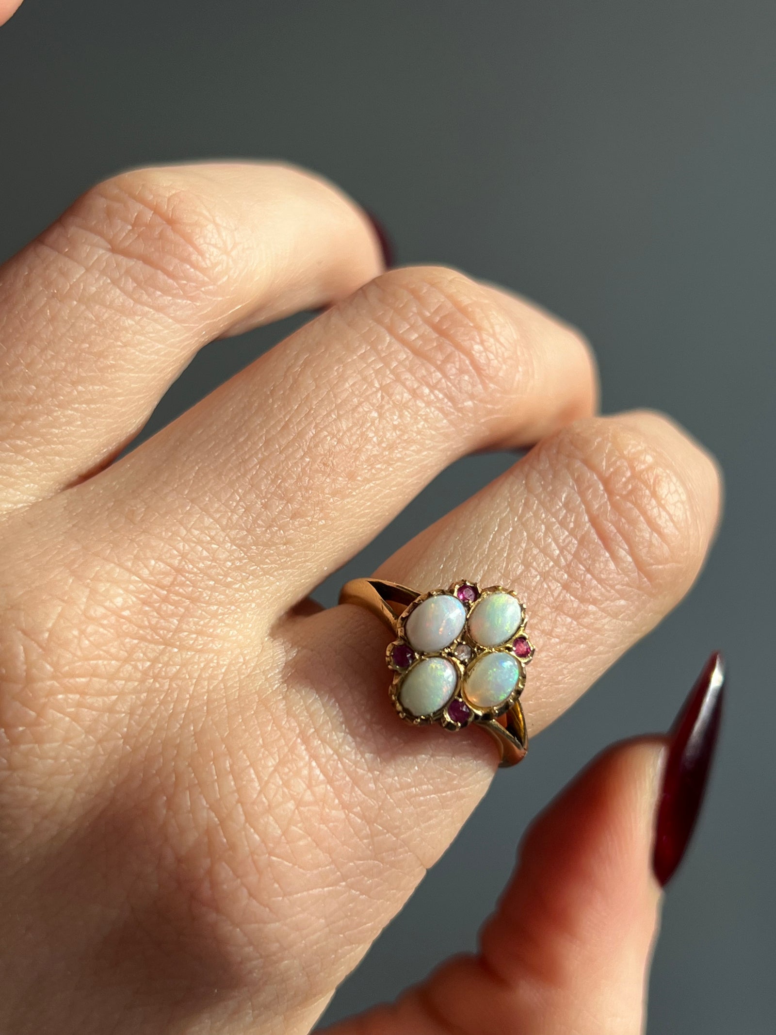 18ct gold opal and ruby flower ring with vibrant opal center and ruby petal design