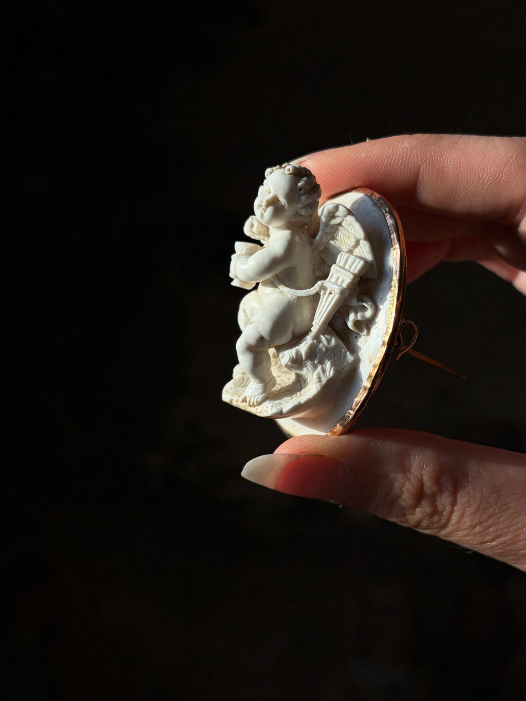 Side view of the antique lava cameo, showing Cupid’s projecting figure, wing and quiver