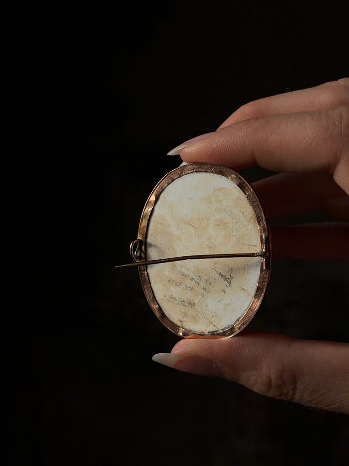 Reverse of the c.1860 lava cameo brooch, showing the stone back, gold bezel and pin fastening