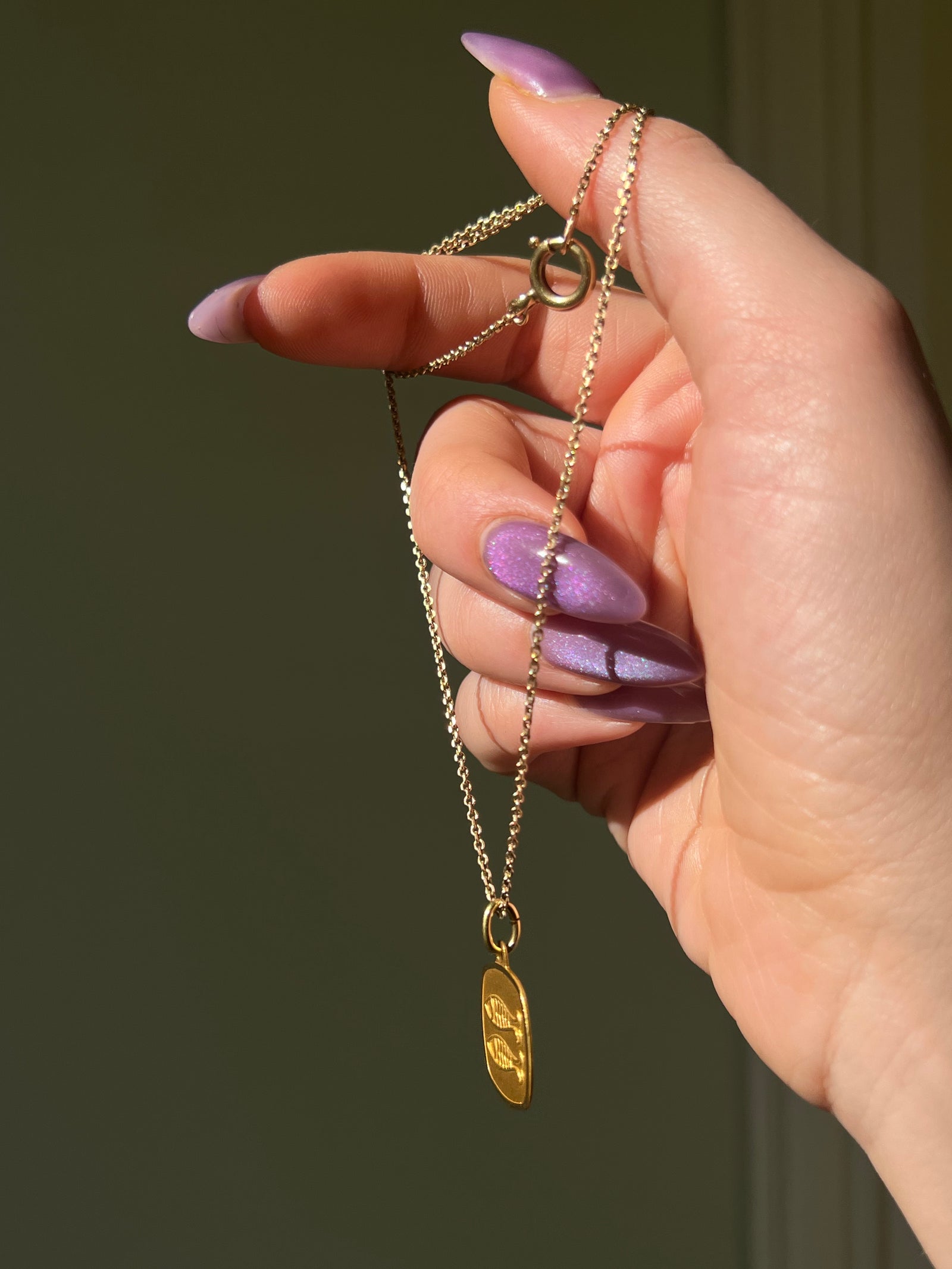 Vintage Pisces zodiac charm with attached chain in antique metal finish