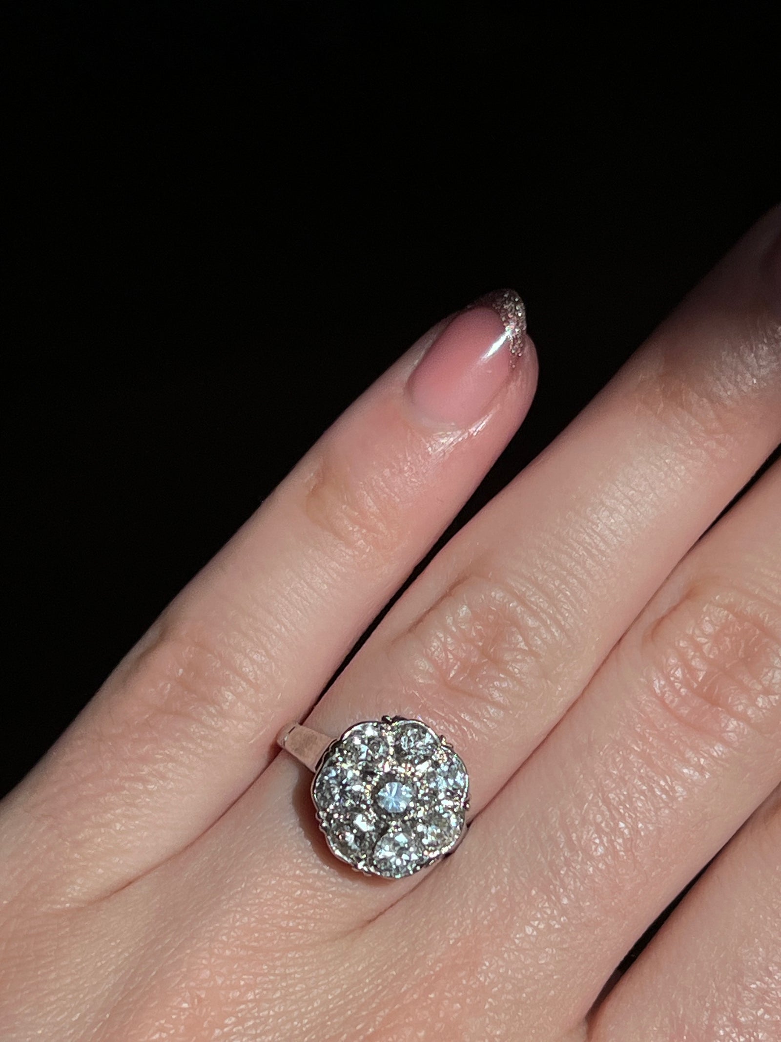 Post Deco platinum and diamond daisy ring featuring a sparkling cluster of diamonds arranged in a floral daisy motif set in elegant platinum.