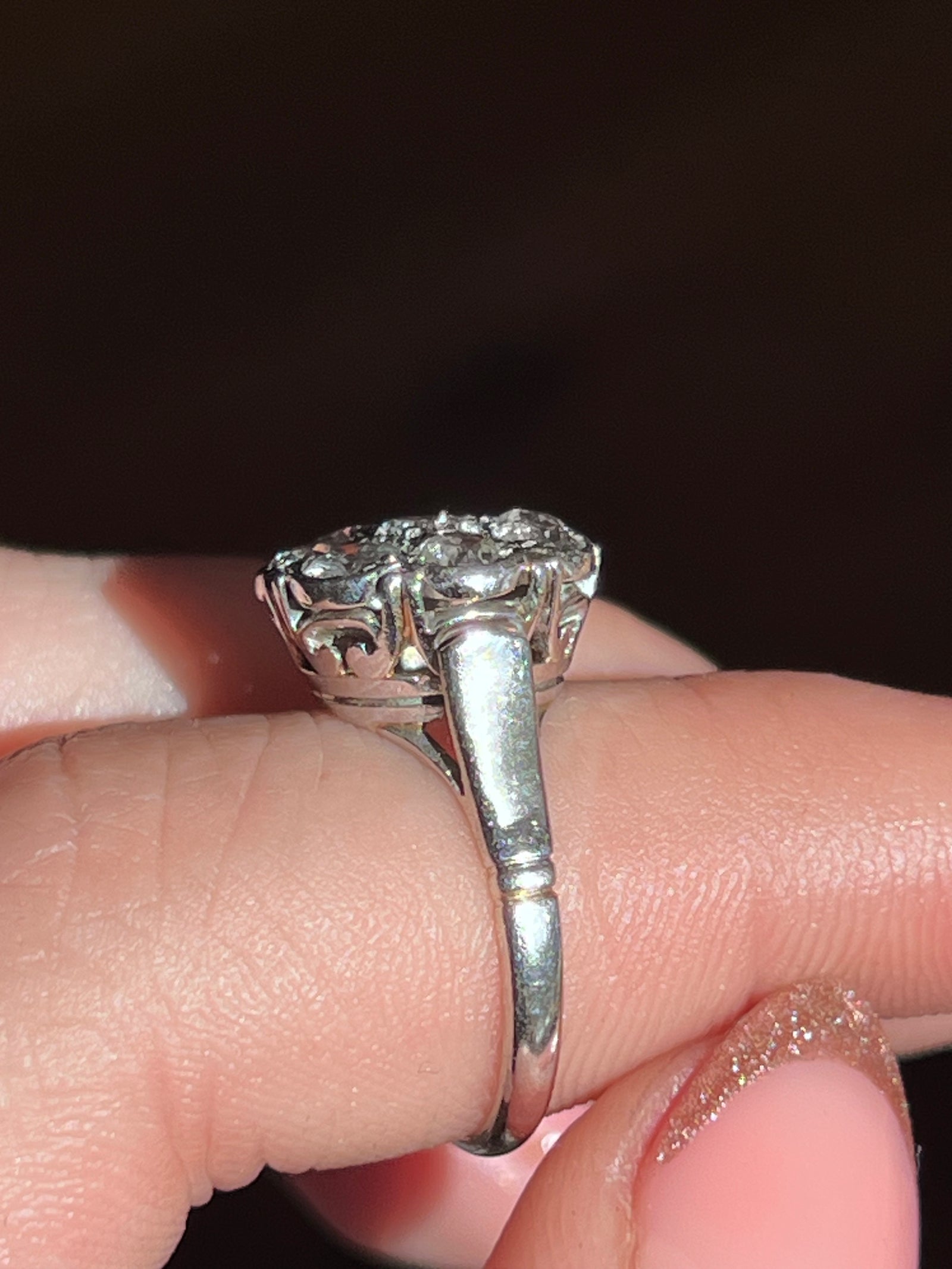 Post Deco platinum and diamond daisy ring featuring a sparkling cluster of diamonds arranged in a floral daisy motif set in elegant platinum.